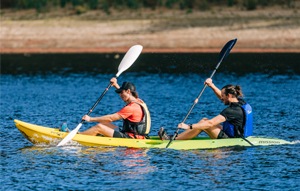 Two people canoeing on a reservoir
